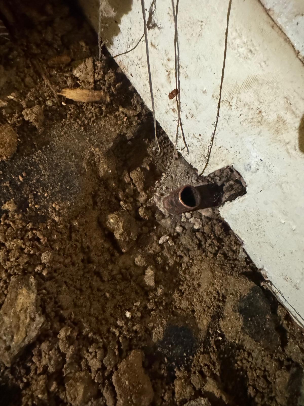 Corroded underground drain pipe uncovered during drainage repair