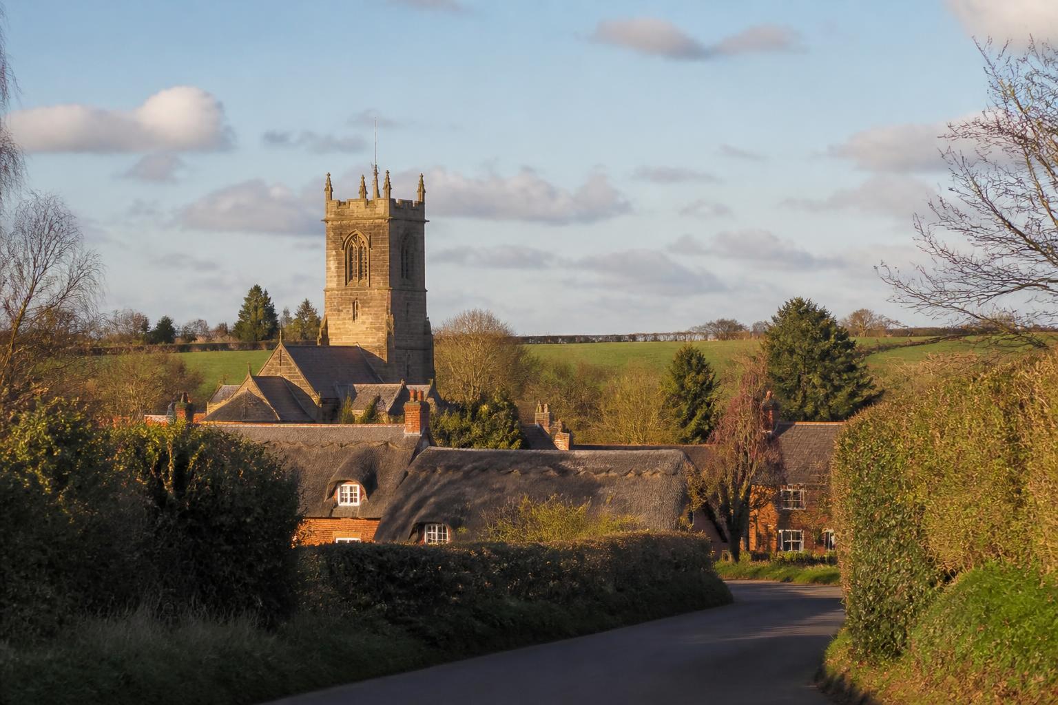 Broughton Astley village with the sandstone tower of St Mary's church and thatched cottages